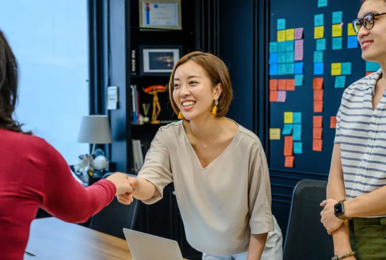 Colleagues shaking hands in a meeting